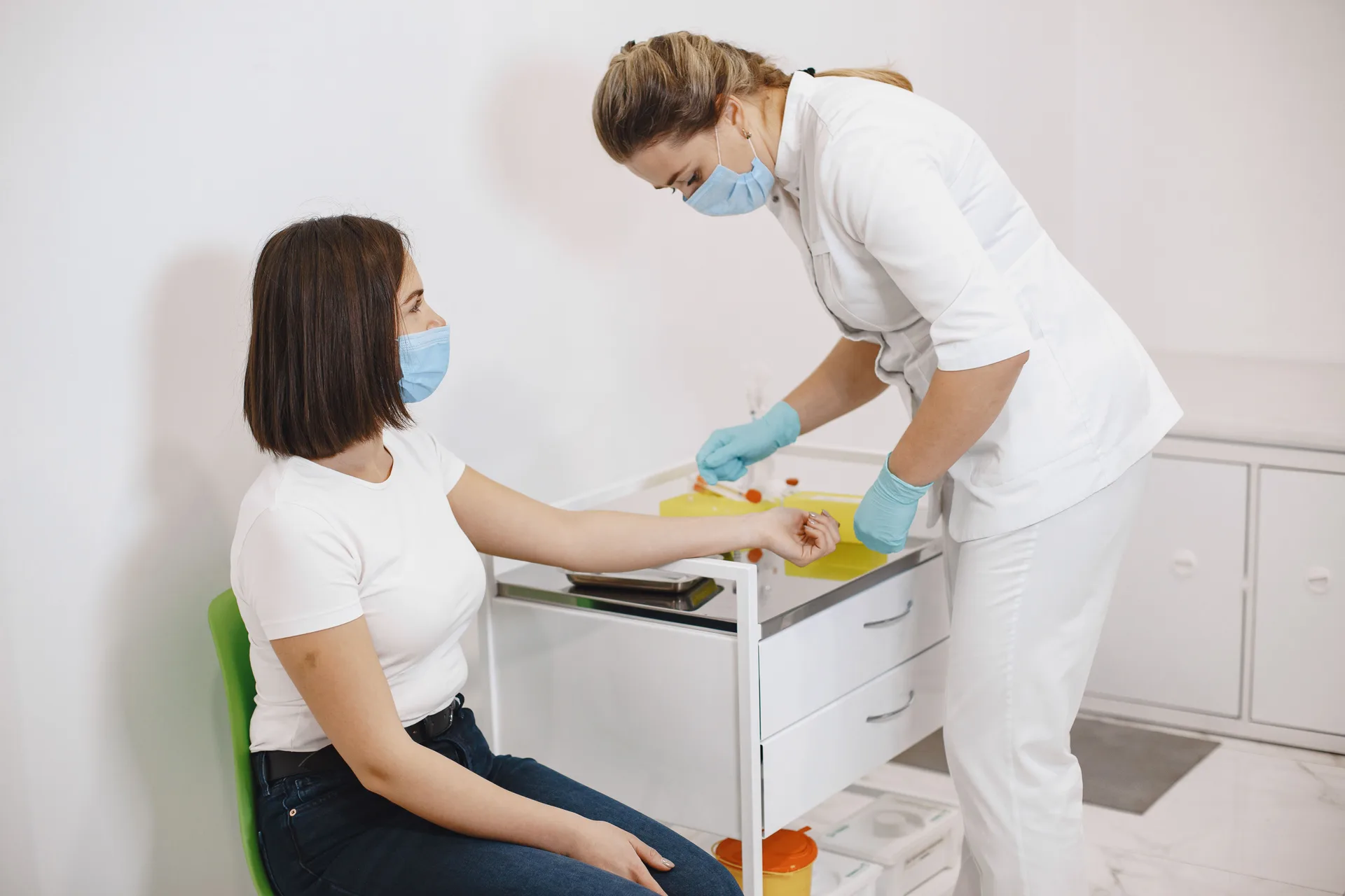 Nurse drawing blood from a patient during a clinical visit